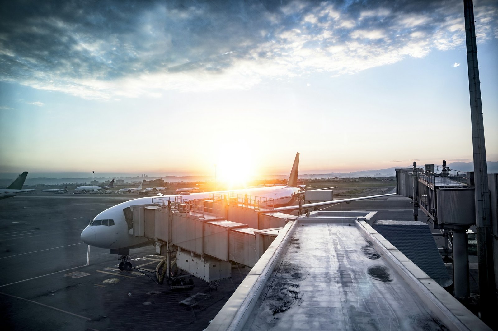 Beautiful shot of an airplane at the station with the sun shining in the background